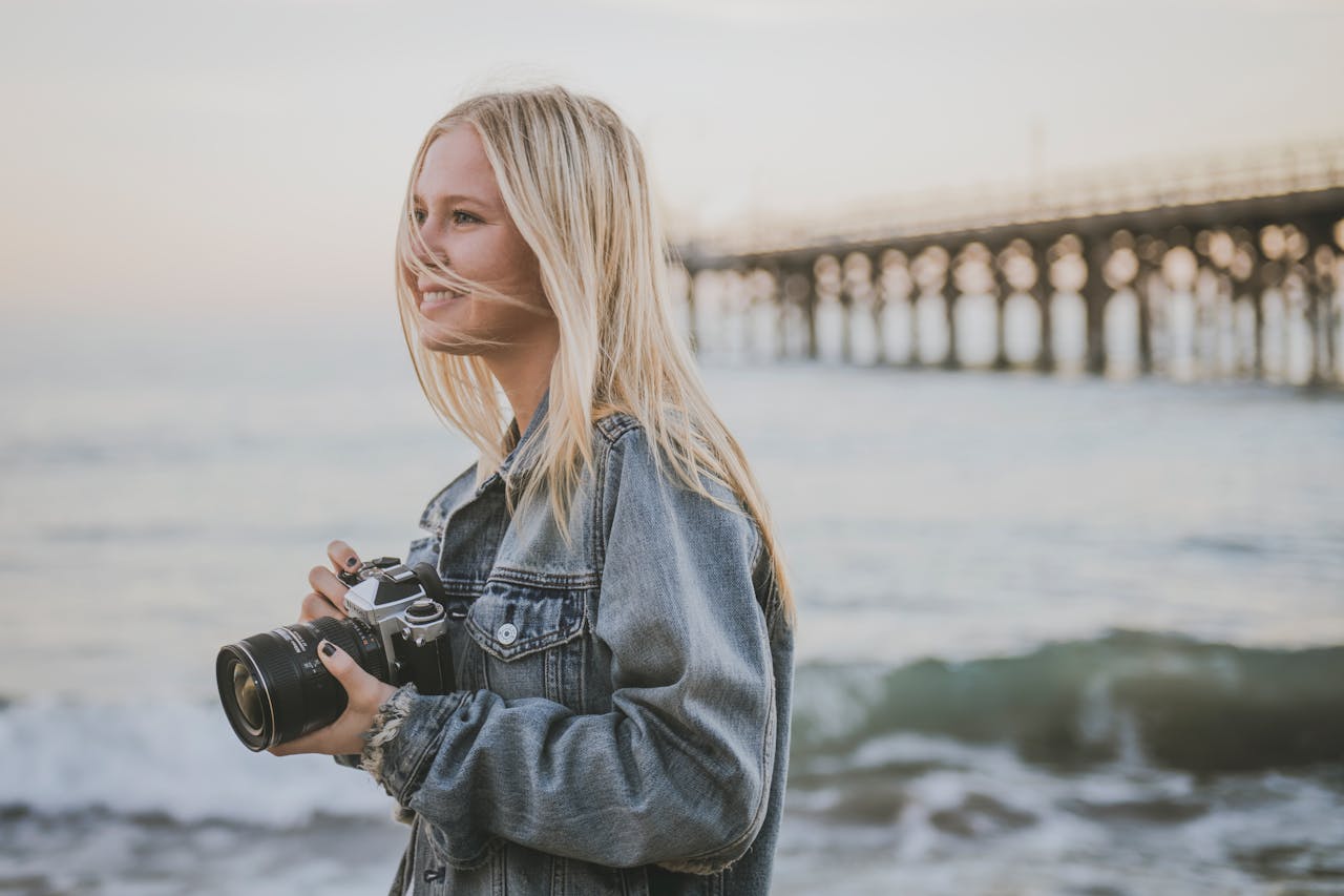 A young photographer captures the serene beach vibes at sunset in Gaviota, California.